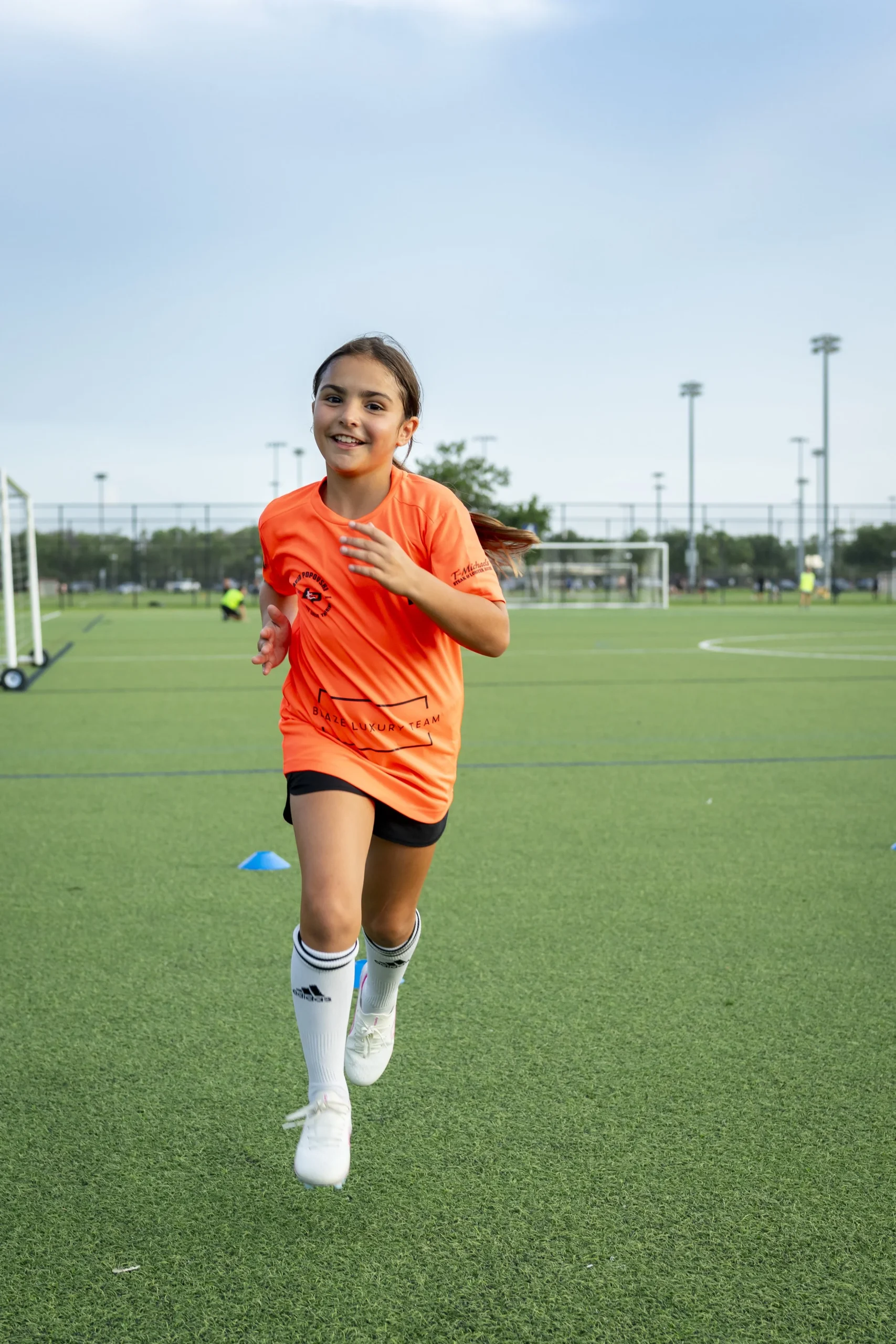 Young player dribbling the ball at a DP Soccer session