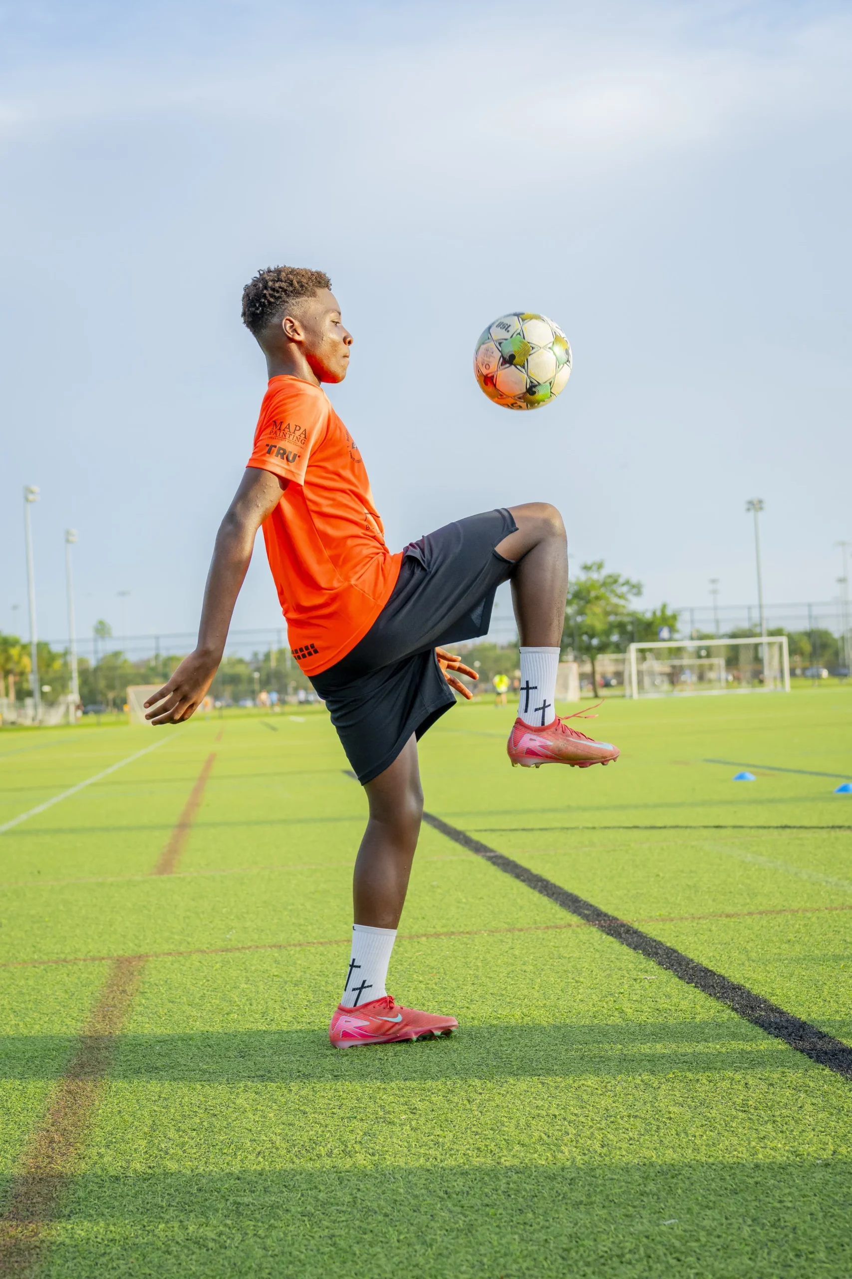 Young player juggling a soccer ball at a DP Soccer session in Naples