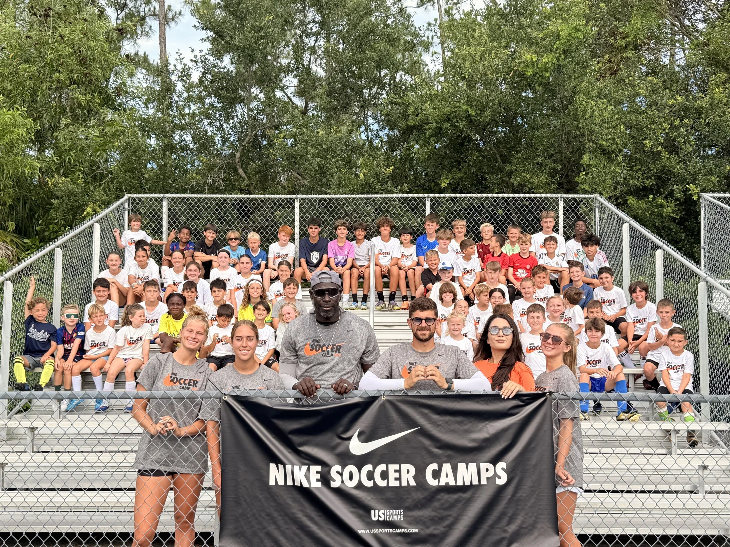 Campers and coaches with the Nike Soccer Camps banner at last year’s camp in Naples
